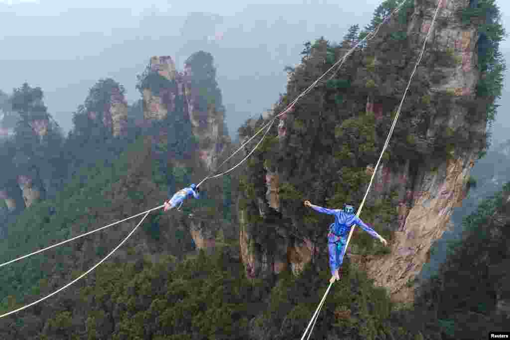 Contestants dressed as characters from the movie &quot;Avatar&quot; take part in a tightrope walking contest in Wulingyuan Scenic Area of Zhangjiajie, Hunan province, China.