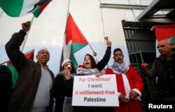 Palestinians take part in a protest at an Israeli checkpoint, in Bethlehem, in the Israeli-occupied West Bank, Dec. 23, 2018.