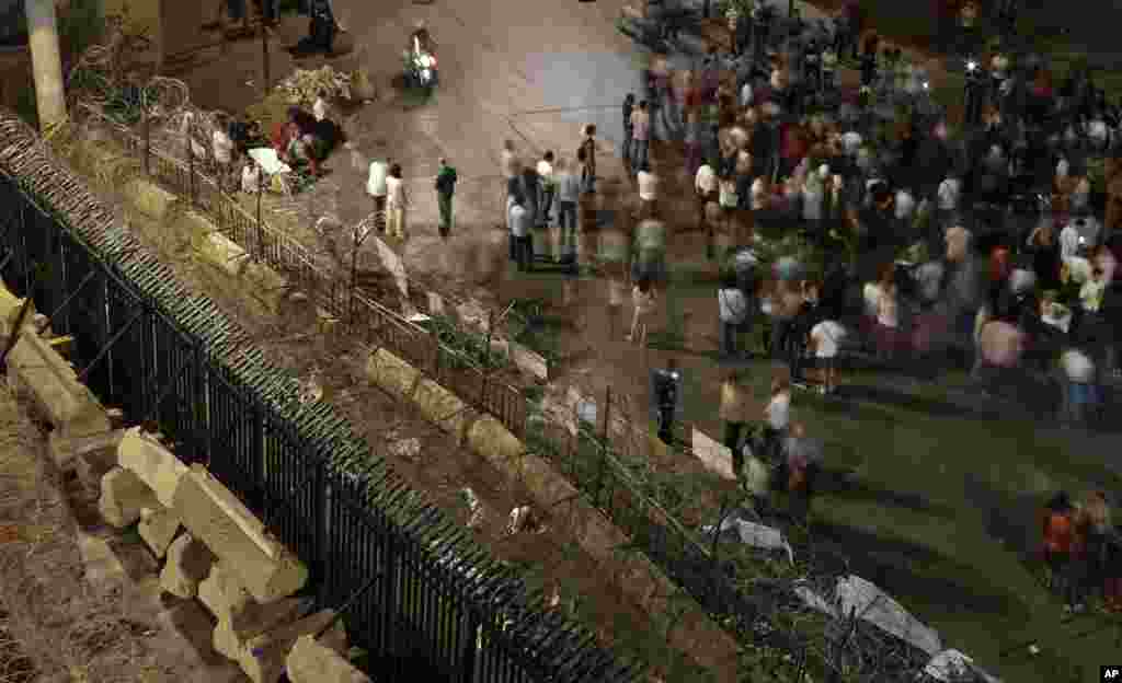 Lebanese anti-government protesters shout slogans as they stand near metal barricades and reinforcements that were installed as extra security measures around the Lebanese&nbsp;government building, in Beirut, Sept. 2, 2015.