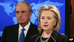 Secretary of State Hillary Rodham Clinton (R) speaks while flanked by Special Envoy for Middle East Peace Talks, Senator George Mitchell, 20 August 2010