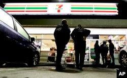 U.S. Immigration and Customs Enforcement agents serve an employment audit notice at a 7-Eleven convenience store, Jan. 10, 2018, in Los Angeles.