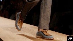 FILE - Footwear by Italian shoemaker Salvatore Ferragamo is being introduced at a fashion show.
