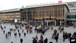 People walk across the square in front of the main station in Cologne, Germany, Wednesday, Jan. 6, 2016. More women have come forward alleging they were sexually assaulted and robbed during New Year’s celebrations in the German city of Cologne, as police faced mounting criticism for their handling of the incident. (AP Photo/Hermann J. Knippertz)