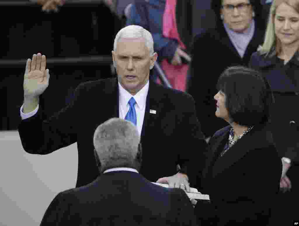 Vice President Mike Pence takes his oatch of office during the 58th Presidential Inauguration at the U.S. Capitol in Washington, Jan. 20, 2017. At his right is his wife Karen. 
