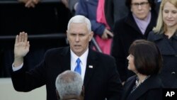 Vice President Mike Pence takes his oatch of office during the 58th Presidential Inauguration at the U.S. Capitol in Washington, Jan. 20, 2017. At his right is his wife Karen.