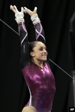 Jordyn Wieber smiles after completing her uneven-bar routine at the US gymnastics championships Sunday, June 10, 2012, in St. Louis. Wieber took the overall title.