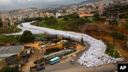 FILE -- Garbage bags line a street in Jdeideh, east Beirut, Lebanon, March 3, 2016. The Lebanese government has announced a temporary solution for the country’s eight-month trash crisis, saying three landfills will be opened.