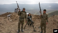 FILE - Armenian soldiers pose near a frontline in Nagorno-Karabakh, Azerbaijan, April 6, 2016. 