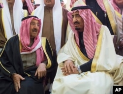 In this photo provided by Saudi Press Agency, newly enthroned King Salman, right, talks with Kuwait's emir, Sheikh Sabah Al-Ahmad Al-Jaber Al-Sabah, during King Abdullah's funeral in Riyadh, Jan. 23, 2015.