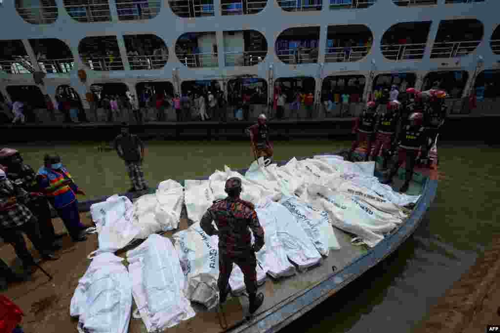 Rescue workers bring bodies of victims after a ferry capsized at the Sadarghat ferry terminal in Dhaka, Bangladesh.