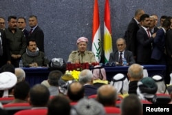 Iraqi Kurdish President Masoud Barzani sits with Kirkuk Governor Najmaldin Karim (R) during his visit in Kirkuk, Iraq, Sept. 12, 2017.