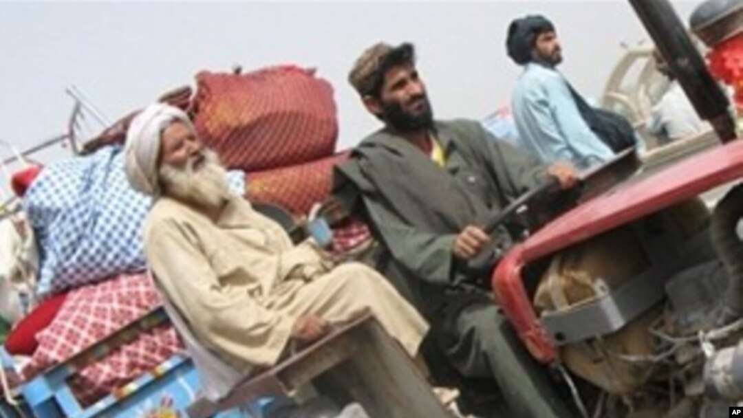 A displaced family flees ahead of an anti-Taliban offensive in Afghanistan's southern Helmand Province, arriving in the town of Lashkar Gah from nearby Marjah. A huge force of US Marines leading NATO and Afghan soldiers is expected to launch the offensive