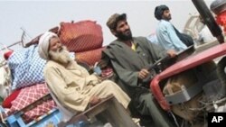 A displaced family flees ahead of an anti-Taliban offensive in Afghanistan's southern Helmand Province, arriving in the town of Lashkar Gah from nearby Marjah. A huge force of US Marines leading NATO and Afghan soldiers is expected to launch the offensive