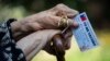 Alicia Martinez holds her vaccination card while resting after her second shot of China's Sinovac COVID-19 vaccine in the outdoor patio of a home for the elderly in Santiago, Chile.