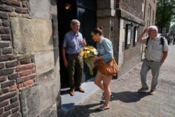 People arrive to pay tribute to attacked journalist Peter R. de Vries at Westerkerk church in Amsterdam, Netherlands, July 9, 2021.