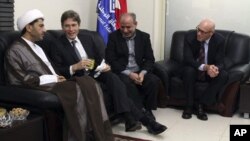U.S. Assistant Secretary of State for Democracy, Human Rights and Labor Tom Malinowski, second from left, visits with Sheikh Ali Salman, head of al-Wefaq National Islamic Society, left, former member of the Bahraini parliament, Abdul Jalil Khalil, second from right, and Timothy J. Pounds, Deputy Chief of Mission at the US Embassy in Bahrain, right, in Manama, July 6, 2014.
