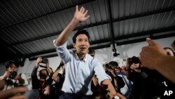 FILE - Former leader of Move Forward Party, Pita Limjaroenrat, center, shakes hands with his supporters at the party's headquarters in Bangkok, Thailand, on Aug. 7, 2024. 