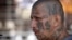 FILE - a gang member of MS-13 attends mass at a prison in Ciudad Barrios, El Salvador. MS-13, or the Mara Salvatrucha, is believed by federal prosecutors to have thousands of members across the U.S., primarily immigrants from Central America. 