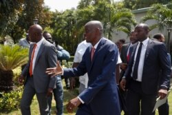 President Jovenel Moïse reaches out to greet journalists after a press conference at the National Palace in Port-au-Prince, Haiti, Oct. 15, 2019.