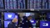 FILE - Traders work on the trading floor at the New York Stock Exchange (NYSE) in Manhattan, New York City, Dec. 28, 2021. 