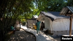 FILE - A medical worker walks through the cholera ward at a clinic run by Doctors Without Borders in the Cite Soleil neighborhood in Port-au-Prince, Haiti, Feb. 3,2023.