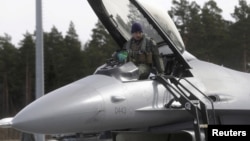 FILE - A U.S. Air Force 510th Fighter Squadron pilot leaves his F-16 fighter in Amari air base March 26, 2015. 