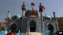 Afghanistan Ashoura: In this Sunday, Oct. 9, 2016. photo, an Afghan Shiite girl runs in front of the Karti Sakhi shrine during a commemoration of Ashoura in Kabul, Afghanistan, Afghanistan’s Shiite population is preparing to mark the martyrdom of the Prophet Mohammad’s grandson with candlelight vigils and mass flagellations despite warnings from authorities of possible attacks following a suicide bombing on a street protest in July that killed at least 80 people.