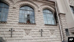 The damaged windows of a building housing the studios of director Alexei Uchitel, after unidentified assailants attempted to set it on fire, in St. Petersburg, Russia, Aug. 31, 2017. 