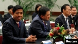 FILE - (From L to R) Cambodia's Secretary of State, Ministry of Finance and Economy Kong Vibol, Philippines Secretary of the Department of Finance Cesar Purisima, and Indonesia's Finance Minister Agus Martowardojo meet at the APEC Summit in Honolulu, Hawaii, Nov. 10, 2011.