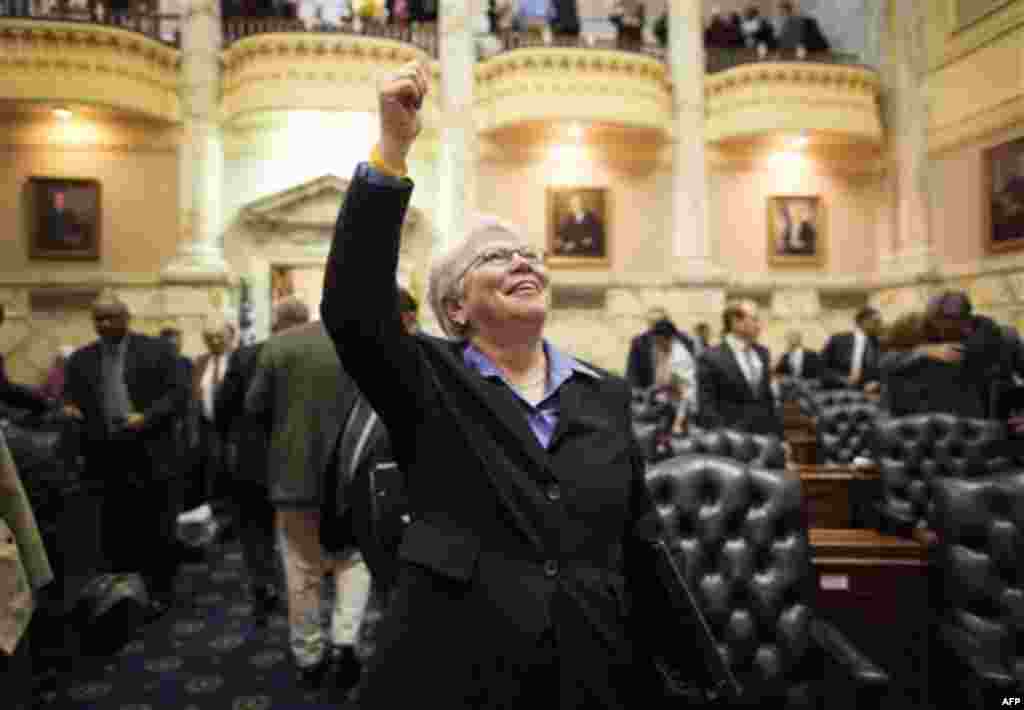 Rep. Maggie McIntosh, D-Baltimore City, gives a thumbs up to spectators in a balcony above the House floor after members of the Maryland House of Delegates passed a gay marriage bill in Annapolis, Md., Friday, Feb. 17, 2012. (AP Photo/Patrick Semansky)