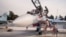 FILE - Russian air force pilots, assisted by ground personnel, climb into their fighter jet at Hemeimeem airbase, Syria, Oct. 22, 2015.