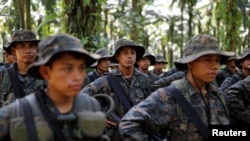 Soldiers stand in formation during a temporary state of siege, approved by the Guatemalan Congress following the death of several soldiers last week, in the community of Semuy II, Izabal province, Guatemala, Sept. 9, 2019. 