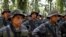 Soldiers stand in formation during a temporary state of siege, approved by the Guatemalan Congress following the death of several soldiers last week, in the community of Semuy II, Izabal province, Guatemala, Sept. 9, 2019. 