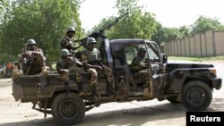 FILE - Niger soldiers provide security for an anti-Boko Haram summit in Diffa city, Niger, Sept. 3, 2015.