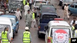 A convoy carrying doctors, medicines and activists with the Falah-e-Insaniat Foundation passes through Chakothi's main bazaar near the Line of Control along the Indian border, 61 kilometers from Muzaffarabad, Pakistan, Aug. 2, 2016.