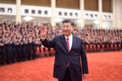 FILE - Chinese President Xi Jinping waves during a ceremony at the Great Hall of the People in Beijing, June 29, 2021, in this photo released by Xinhua News Agency..