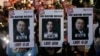 Protesters with images of South Korean President Yoon Suk Yeol and former South Korea Defense Minister Kim Yong Hyun, center, march to the presidential office in Seoul, South Korea, on Dec. 5, 2024. The signs read "Arrest the rebellion criminals."