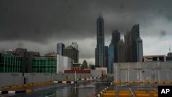 Storm clouds cover up the tops of buildings in the Dubai Marina as rain falls on a parking lot that stands empty over the coronavirus pandemic in Dubai, United Arab Emirates, April 15, 2020.