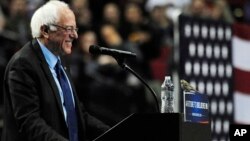 Democratic presidential candidate Bernie Sanders smiles as a bird lands on his podium when he addresses the crowd during a rally at the Moda Center in Portland, Ore., Friday, March 25, 2016. (AP Photo/Steve Dykes)