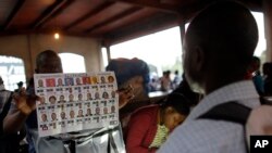 FILE - Electoral workers count ballots at a polling station in Port-au-Prince, Haiti, Nov. 20, 2016. The ruling by the National Electoral Litigation Office orders an audit of 12 percent of vote tallies nationwide, watched by Haitian and international monitors.