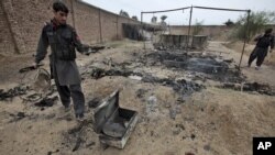 Pakistani paramilitary soldiers check the site of an attack by militants in the town of Matni, near Peshawar, Pakistan, Oct. 15, 2012. 