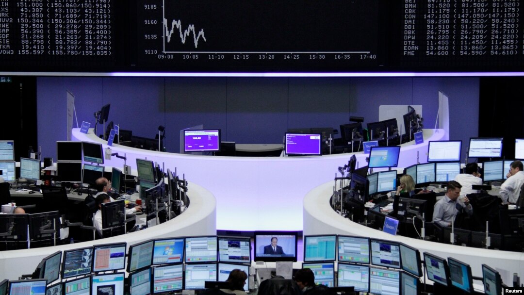 Traders at their desks at the Frankfurt stock exchange, Oct. 7, 2014. While stock market prices have risen, other investments have been subdued, according to the International Monetary Fund (IMF). 