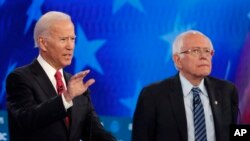 DILE - Democratic presidential candidate former vice president Joe Biden, left, speaks as Sen. Bernie Sanders listens during a Democratic presidential primary debate, Nov. 20, 2019.