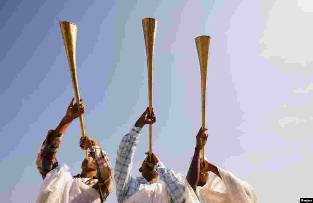 Ethiopian Orthodox faithful blow traditional trumpets during the annual Epiphany celebration called &quot;Timket&quot; to commemorate Jesus Christ&#39;s baptism in the Jordan River by John the Baptist, in Batu, Ethiopia.