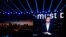 FILE PHOTO: CEO of Ant Group Simon Hu is seen on a giant screen as he delivers a speech at the INCLUSION Fintech Conference in Shanghai.