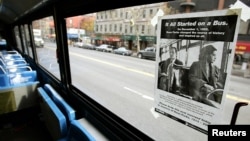 FILE - A poster entitled "It All Started On A Bus," is pasted above the front seat of a New York City bus to honor Rosa Parks in New York, Dec. 1, 2005. 