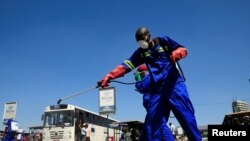 City health workers spray disinfectant at a bus terminus during a 21 day nationwide lockdown to limit the spread of coronavirus disease (COVID-19) in Harare, Zimbabwe, April 1, 2020. REUTERS/Philimon Bulawayo