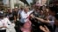 Anti-government protest leader Suthep Thaugsuban collects donation from supporters during a march through Bangkok, Thailand, Feb. 3, 2014. 