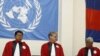 Cambodian military officials line up in front the top leaders of Khmer Rouge portraits, from right, former Khmer Rouge Foreign Minister Ieng Sary, former Khmer Rouge head of state Khieu Samphan, and former Deputy Secretary Nuon Chea, during the second d