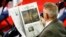 A man on the floor of the convention reads The Washington Post before the start of the second session of the RNC.